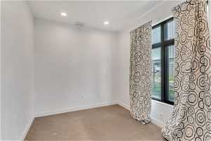 Carpeted spare room with a wealth of natural light