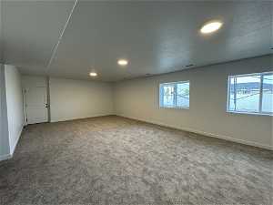 Unfurnished room with carpet flooring and a healthy amount of sunlight