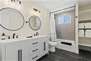 Full bathroom featuring shower / bath combination with curtain, toilet, dual vanity, and tile flooring