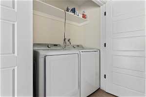 Washroom featuring washer hookup, hardwood / wood-style floors, and independent washer and dryer