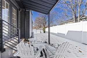 Snow covered patio with central air condition unit