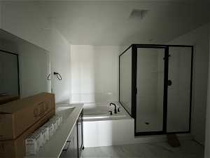 Bathroom with tile floors and shower with separate bathtub