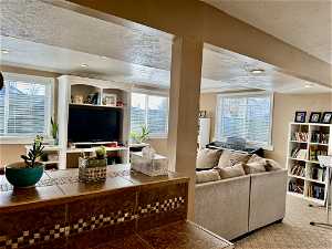 Carpeted family room featuring a large windows