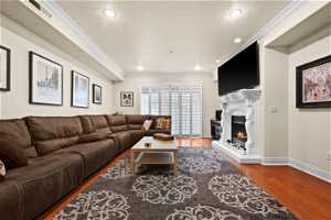 Living room with crown molding, dark hardwood / wood-style flooring, and a textured ceiling