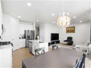 Dining area featuring a chandelier, light hardwood / wood-style floors, and sink