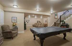 Playroom with light colored carpet and pool table