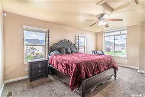 Carpeted Master bedroom with multiple windows and ceiling fan