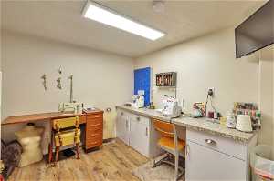 Craft room featuring a textured ceiling and light hardwood / wood-style flooring