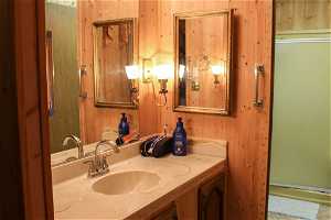 Bathroom with wooden walls and large vanity