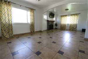 Unfurnished living room with tile floors