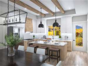 Kitchen with an inviting chandelier, light hardwood / wood-style flooring, premium range hood, a kitchen island, and pendant lighting