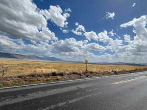 View of road with a rural view and a mountain view