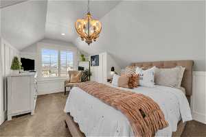 Bedroom with a notable chandelier, light colored carpet, and lofted ceiling