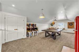 Playroom featuring light carpet and vaulted ceiling