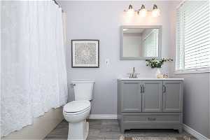 Bathroom featuring vanity, hardwood / wood-style floors, and toilet