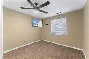 Bedroom 5 featuring ceiling fan and carpet