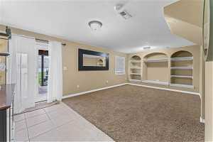 Basement family room featuring walk out to patio and hot tub.
