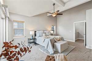 Carpeted bedroom featuring high vaulted ceiling, beam ceiling, and ceiling fan