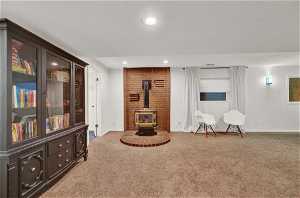Very large and open living area with brick wood stove, and light carpet