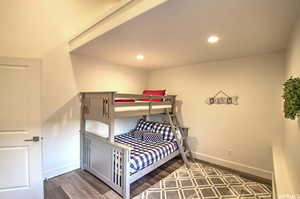 Bedroom with dark wood-type flooring