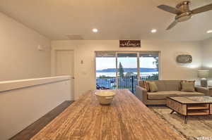 Living room with wood-type flooring and ceiling fan