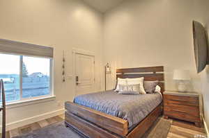 Bedroom featuring lofted ceiling and wood-type flooring