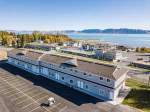 Birds eye view of property featuring a water and mountain view