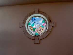 Port style stained glass round window