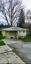 View of side of home with a carport