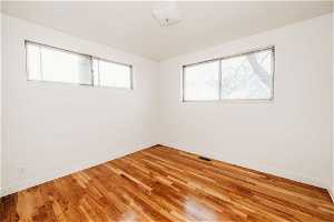 Bedroom #2 - featuring light hardwood / wood-style floors and a healthy amount of sunlight