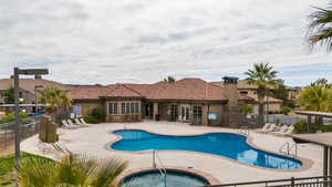 View of pool featuring a patio and a hot tub