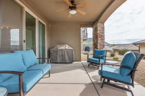 View of patio with outdoor lounge area, area for grilling, with ceiling fan