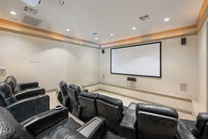 Cinema room featuring carpet and ornamental molding