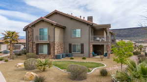 Back of house with a balcony and a patio