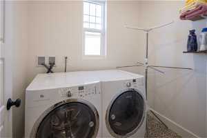 Washroom featuring washer hookup, tile floors, and independent washer and dryer
