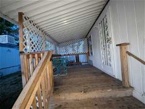 View of wooden deck leading to door entry