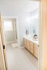 Upstairs bathroom featuring tile floors and vanity