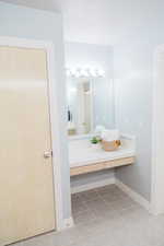 Upstairs bathroom featuring tile floors and vanity