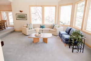 Carpeted living room with plenty of natural light and french doors