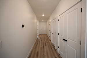 Corridor featuring light hardwood / wood-style floors