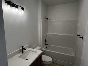 Full bathroom featuring wood-type flooring, vanity, toilet, and shower / bathtub combination