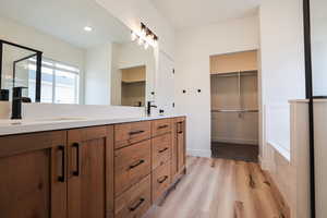 Bathroom with hardwood / wood-style floors and vanity