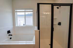 Bathroom featuring plus walk in shower