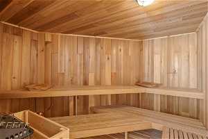 View of sauna with wood walls and wooden ceiling