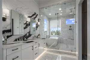 Bathroom with walk in shower, backsplash, dual sinks, tile flooring, and large vanity