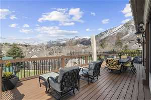 Deck with an outdoor living space and a mountain view
