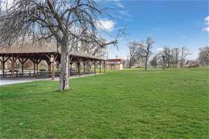 Surrounding community with a gazebo and a yard Romrell Park.