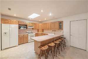 Large bar in kitchen can seat 6. Skylights in kitchen and adjoining great room usher in the sunshine.
