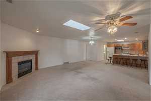 Natural flow from great room into kitchen. Skylight adds natural light to the room.