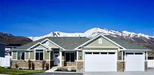Craftsman inspired home with a mountain view and a garage beautiful views and 3 car garage with extra heighth and width.